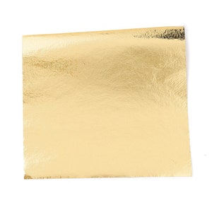 Peut inclure: Une feuille d'or, un matériau métallique fin utilisé à des fins décoratives.