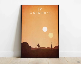 May include: Framed poster with a minimalist desert landscape design, featuring a dual sun and the text "IV A NEW HOPE". A figure stands on a dune, with structures and a tower in the background. The color palette is warm, with shades of orange and brown.