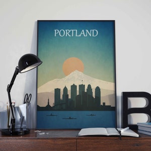 May include: A vintage-style poster with a blue, green and orange colour scheme depicting the Portland skyline with Mount Hood in the background. The text "PORTLAND" is at the top of the poster.