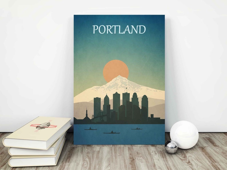 May include: A vintage-style illustration of the Portland skyline with Mount Hood in the background. The city is depicted in silhouette against a blue and orange sunset sky. The text "PORTLAND" is displayed at the top of the image.