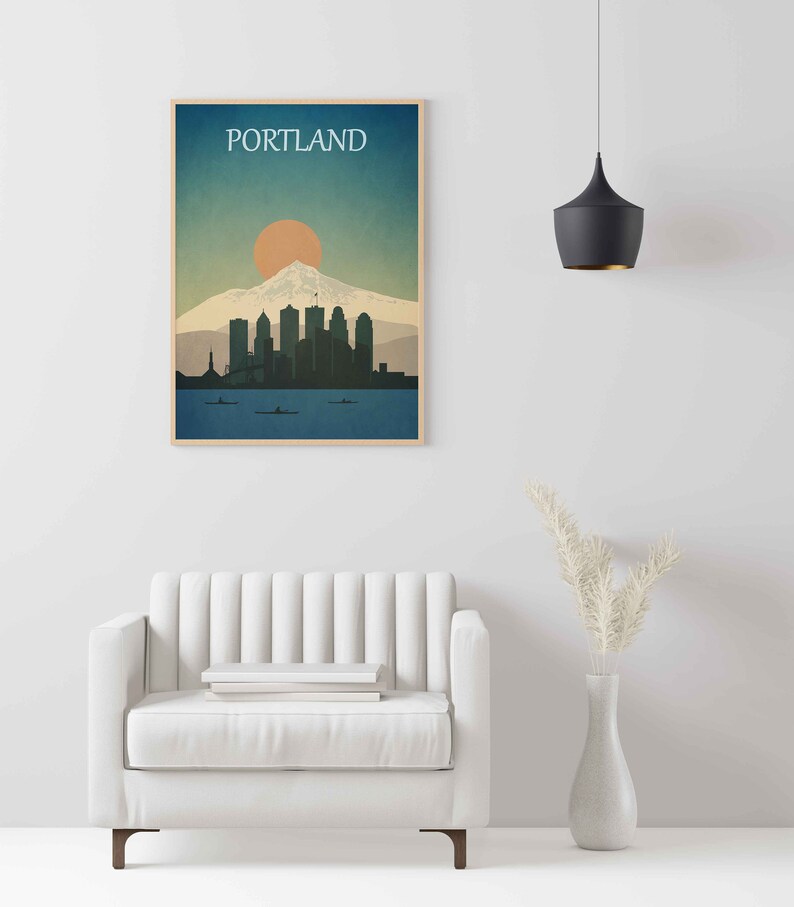May include: A minimalist poster with a blue, green and orange colour scheme depicting the Portland skyline with Mount Hood in the background. The text "PORTLAND" is at the top of the poster.