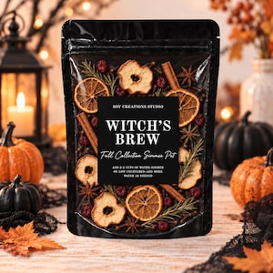 May include: A black stand-up pouch containing a dried potpourri simmer pot mix. The label reads: SOY CREATIONS STUDIO, WITCH'S BREW, Fall Collection Simmer Pot, ADD 2-3 CUPS OF WATER-SIMMER ON LOW UNCOVERED-ADD MORE WATER AS NEEDED. Visible ingredients include dried orange slices, apple slices, cinnamon sticks, star anise, rosemary, and red berries.
