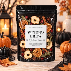 May include: A black pouch containing a potpourri mix of dried orange slices, apple rings, cinnamon sticks, star anise, rosemary, and red berries. A white label reads: SOY CREATIONS STUDIO WITCH'S BREW Fall Collection Simmer Pot.