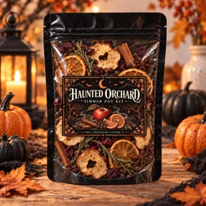 May include: A clear plastic pouch containing a Haunted Orchard simmer pot kit by Soy Creations Studio. The contents include dried apple slices, orange slices, cinnamon sticks, star anise, cranberries, and rosemary sprigs visible through the packaging.