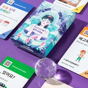May include: A set of colorful flash cards with Korean phrases and pronunciation guides. The cards feature illustrations of people and places in Korea. The cards are designed to help learners of Korean improve their language skills.