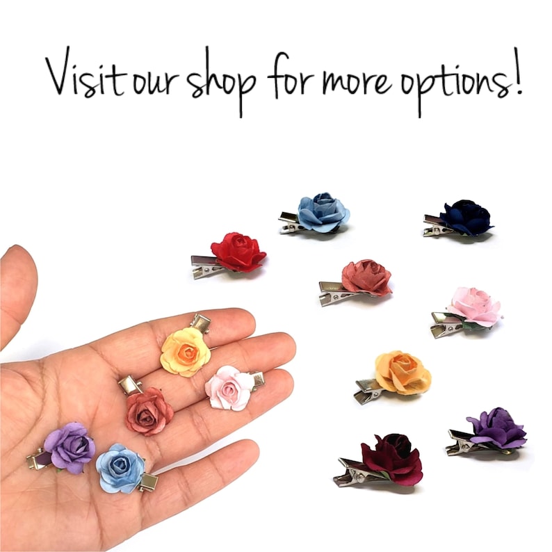May include: Assortment of ten fabric flower hair clips in various colors, including blue, red, yellow, pink, purple, and orange. The clips are displayed on a hand and a white background.