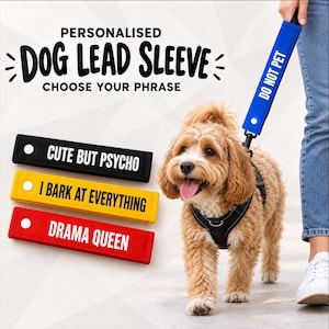 May include: A collection of rectangular fabric dog lead sleeves in black, yellow, and red, each featuring white text: CUTE BUT PSYCHO, I BARK AT EVERYTHING, and DRAMA QUEEN. A blue sleeve with DO NOT PET is attached to a dog lead.