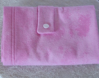 May include: A pink fleece fabric diaper with a white snap closure.