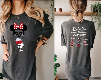 May include: A gray t-shirt with a cartoon image of Minnie Mouse wearing sunglasses and holding a glass of wine. The back of the shirt has the text "Drinking Around the World Checklist" with a list of countries and flags.