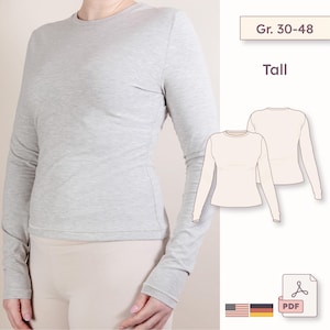 May include: A light gray long-sleeve shirt with a crew neck. The shirt is shown on a person and has a fitted silhouette. The image also includes a diagram of the shirt and the text "Gr. 30-48" and "Tall".