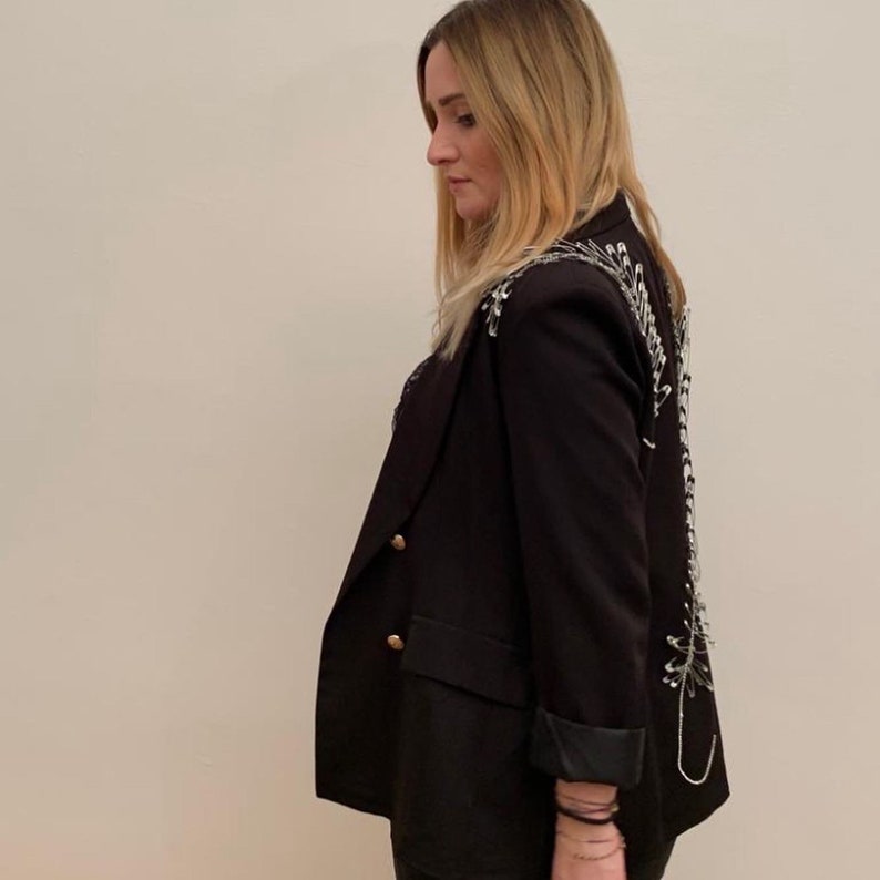 Double-breasted blazer with rhinestone application and hand-attached brooches
