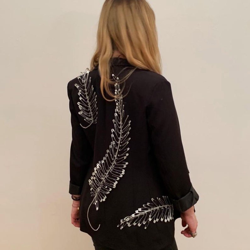 Double-breasted blazer with rhinestone application and hand-attached brooches