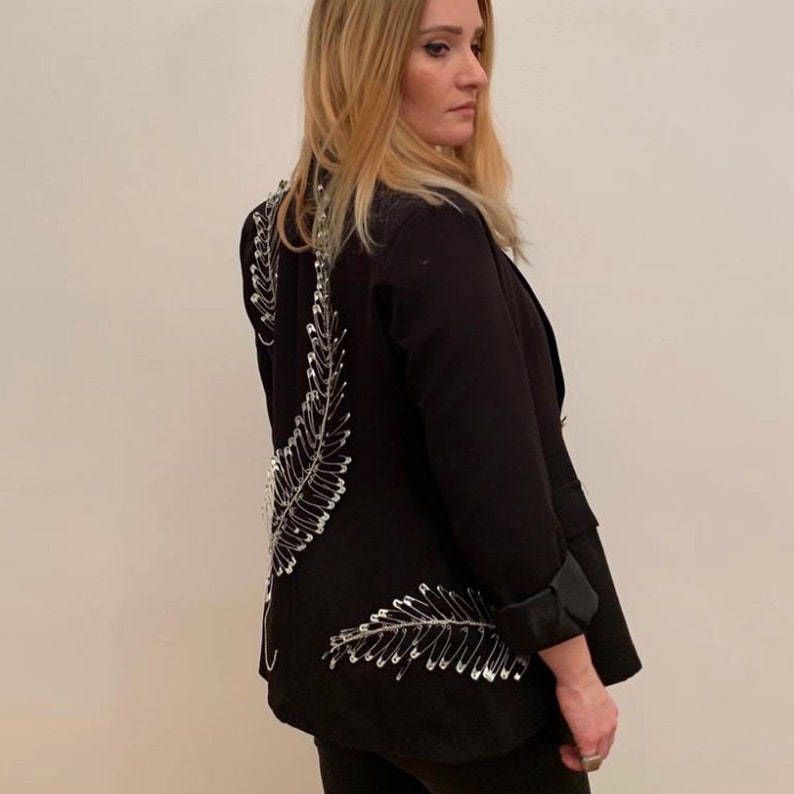 Double-breasted blazer with rhinestone application and hand-attached brooches