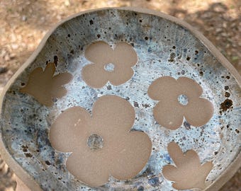 Funky shaped pottery bowl, floral motif with cream and blue- gray glazes