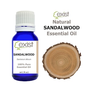 May include: A blue glass bottle of sandalwood essential oil with a white cap. The bottle has a label with the text "exist Natural SANDALWOOD Essential Oil" and "Santalum Album 100% Pure Essential Oil ml (fl oz)".