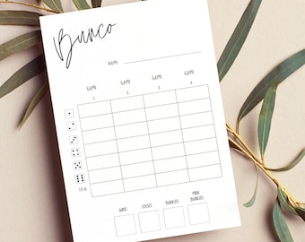May include: A white Bunco score sheet with a handwritten-style "Bunco" title. The sheet includes spaces for name, game numbers, and score tracking. Dice icons are on the left. The sheet is surrounded by green leaves.