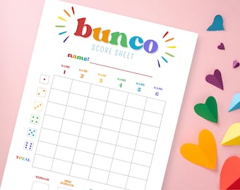 Pode incluir: Uma folha de pontuação de bunco imprimível com um design de arco-íris. A folha tem espaços para seis jogos e uma pontuação total. Também tem espaços para buncos e mini buncos.