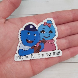 May include: A blue and pink fuzzy monster sticker with the text "Don't You Put it in Your Mouth".