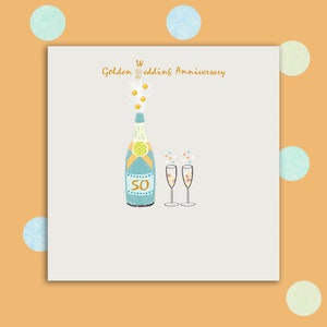 Biglietto per anniversario di matrimonio dorato impreziosito da piccole gemme, bicchieri di champagne, bolle di cuore d'amore
