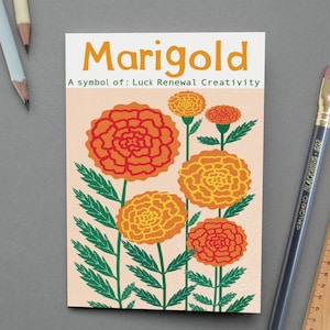 May include: A greeting card featuring a marigold illustration. The card has orange flowers with green stems and leaves against a peach background. The word "Marigold" is at the top, with the text "A symbol of: Luck Renewal Creativity" below.