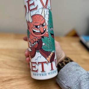 May include: White stainless steel tumbler with a cartoon illustration of a red devil and a green marijuana leaf. The text "Devil's Lettuce" is printed on the tumbler, along with the phrase "Better with friends".