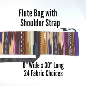 May include: A flute bag with a shoulder strap featuring a multi-coloured geometric pattern in shades of purple, tan, brown, and teal. The bag measures 15.24 cm wide by 76.2 cm long. Text on the image reads: Flute Bag with Shoulder Strap, 6" Wide x 30" Long, 24 Fabric Choices.