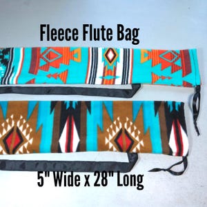May include: Two fleece flute bags measuring 5 inches wide by 28 inches long. The top bag features a turquoise, orange, and white geometric pattern. The bottom bag displays a brown, turquoise, black, and white geometric design with black ties.