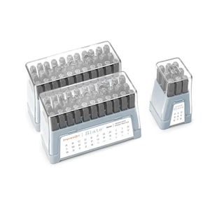 May include: Two sets of grey plastic cases containing metal letter and number stamps. The cases are labelled "ImpressArt Slate" and include uppercase letters and numbers. A smaller grey plastic case with metal number stamps is also shown.