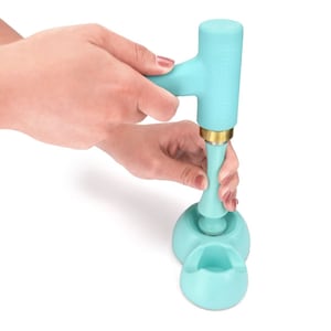 May include: A light blue silicone hand stamp with a gold base and a matching light blue base with three indentations. The stamp is labeled "ImpressArt".