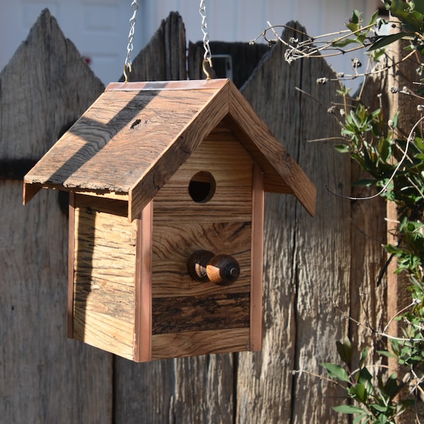 Copper trimmed, solid oak birdhouse.