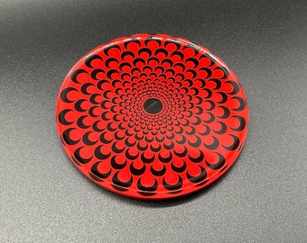 Sous verre très résistant en résine. Mandala rouge et noir peint à l’acrylique sur rondin de bois puis recouvert entièrement de résine.