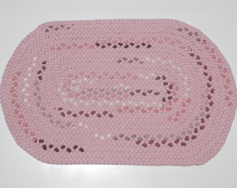 Hand made braided rug, pink oval.