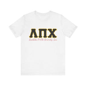 May include: A white t-shirt displaying the Greek letters ΛΠΧ in black with a gold border. Beneath the letters, the text "Lambda Pi Chi Sorority, Inc." is printed in a red, cursive font. The shirt is made of a soft, comfortable material.