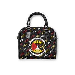 May include: Black satchel bag with a repeating pattern of yellow, red, and white Greek letters. The bag features a circular emblem with a world map and text. The bag has a black handle and trim.