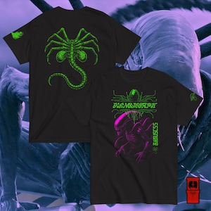 May include: Black t-shirts with neon green and pink alien-themed graphics. One shirt features a spider-like creature, the other displays the word "Xenomorph" and an alien illustration. Both shirts have a small green design on the sleeve.