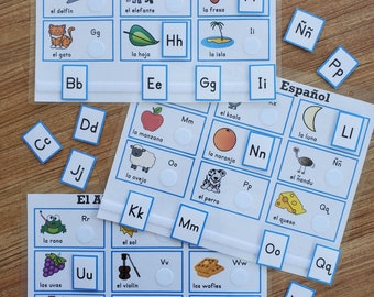May include: A set of colorful flashcards with Spanish alphabet letters and corresponding images. Each card features a blue border and a white background with a picture and the Spanish word for the image. The words "El Alfabeto en Español" are printed at the top of the cards.