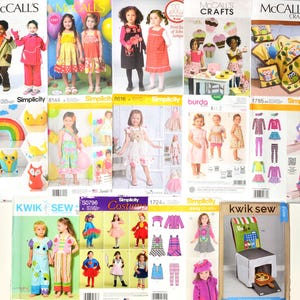 May include: A collection of various sewing pattern envelopes featuring illustrations and photographs of children wearing handmade clothing, costumes, and soft fabric crafts, with brand names like McCall's, Simplicity, Burda, and Kwik Sew visible.