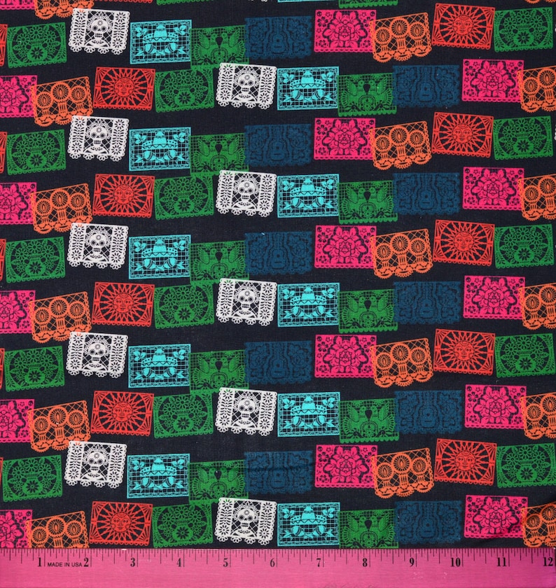 May include: A black fabric with a repeating pattern of colorful paper cutouts. The cutouts are in the shape of squares and rectangles and feature intricate designs. The colors of the cutouts include red, orange, yellow, green, blue, and pink.