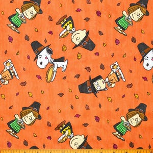 May include: Orange fabric with a repeating pattern of Peanuts characters dressed in pilgrim hats. The characters include Snoopy, Charlie Brown, and Lucy. The fabric is covered in small brown and orange leaves.