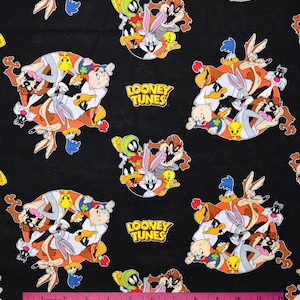 May include: Black fabric with a repeating pattern of cartoon characters from Looney Tunes. The characters include Bugs Bunny, Daffy Duck, Tweety Bird, Sylvester the Cat, Porky Pig, and Tasmanian Devil. The text "Looney Tunes" is repeated throughout the fabric.