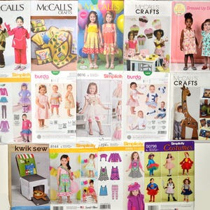 May include: A collection of various sewing pattern envelopes for children's clothing and crafts, featuring brands like McCall's, Simplicity, Burda, and Kwik Sew, displaying illustrations of dresses, costumes, and home decor items with printed text.