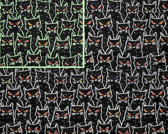 May include: Black fabric with a repeating pattern of white outlined black cats with glowing orange, green, and purple eyes. The fabric has the text "GLOWS IN THE DARK!" printed on it.
