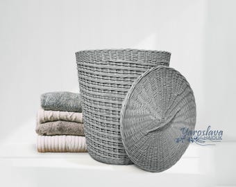 May include: A gray wicker laundry basket with a lid. The basket is woven with a pattern of horizontal and vertical lines. The lid is round and has a similar woven pattern.
