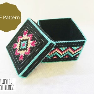 May include: A black square box with a teal border and a colourful geometric pattern on the lid and sides. The lid is open and the inside of the box is black.
