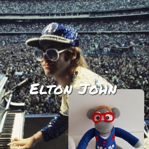 May include: Image of Elton John performing on stage, with the text "ELTON JOHN" in white. A sock monkey doll wearing red glasses, a blue jacket, and white trousers is also visible.