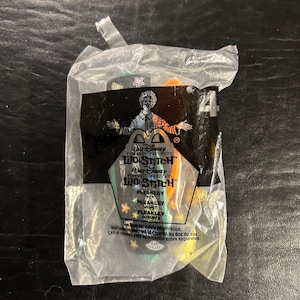 May include: Sealed McDonald's Happy Meal toy featuring a Pleakley character from Disney's Lilo & Stitch. The clear plastic bag displays the movie logo, character name, and the number 4. The toy is colorful with green, orange, and yellow accents.
