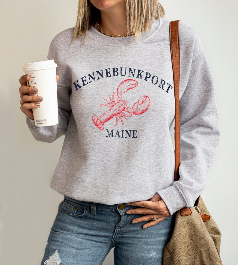 May include: Gray sweatshirt with a red lobster illustration and the text "Kennebunkport Maine".
