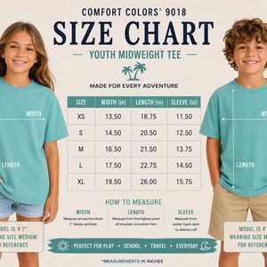 May include: A Comfort Colors 9018 youth midweight tee size chart featuring a table with width, length, and sleeve measurements in inches for sizes XS to XL. The chart includes instructions on how to measure and shows two models wearing size medium.