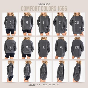 May include: Size guide for Comfort Colors 1566 sweatshirts. The image shows multiple views of the sweatshirt in sizes S, M, L, XL, and 2XL. Measurements are provided in inches. The model is 5'8", 125 lbs, with measurements of 89-71-94 cm.