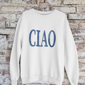 May include: White sweatshirt with a blue "CIAO" graphic printed on the front.